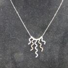 CADENA DE ORO DE 18 K CON COLGANTES